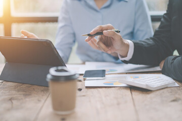 Group of business people meeting together Pointing to the graph assess business profits