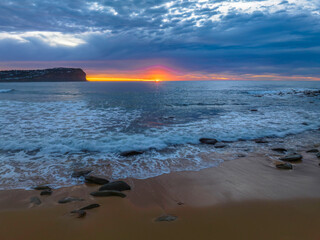 Cloud filled sunrise seascape