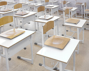 Chairs are on school desks. School furniture.