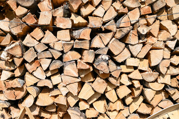Chopped and stacked firewood. Logs of firewood stacked in boxes. Stock for winter.