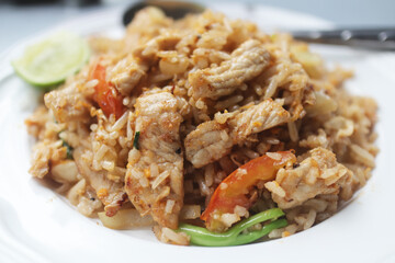 Close up fried rice with pork and vegetables .