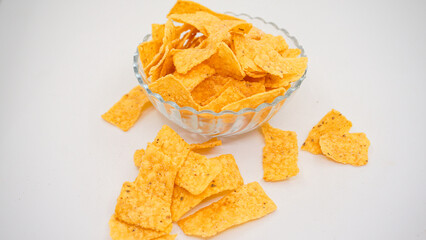 Delicious nachos chips on the glass bowl, isolated on white background