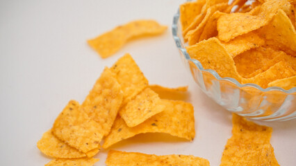 Delicious nachos chips on the glass bowl, isolated on white background