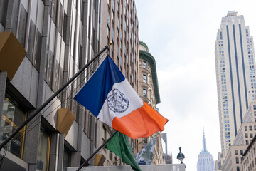The New York City flag on the building in New York, USA. The New York City flag has three vertical...