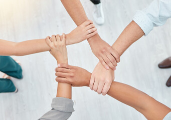 Hope, partnership and support group holding each other at community therapy session. Top view of people doing motivation, love and trust exercise while building a connection at mental health clinic.