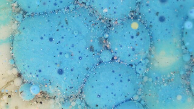 Rotatin blue ink bubbles. Blue foam texture background