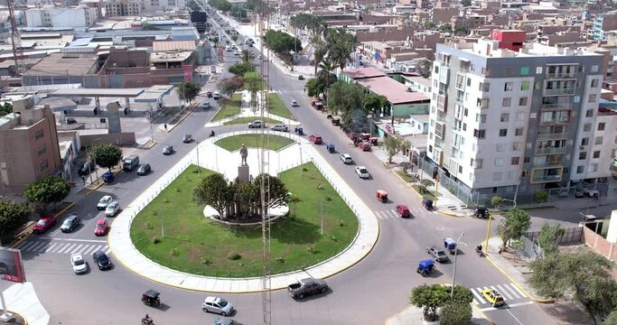 Aerial drone shot of the oval of a small city with heavy car traffic during the day. Chiclayo, Per&uacute;.