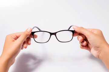 Woman holding the black eye glasses spectacles with shiny black frame isolated on white