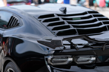 Sport car at the start. Grille on the rear window of the car. Luxury black sports car fragment,...