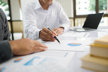 Asisan businessman teamwork meeting and discussing the investment data and report graph.