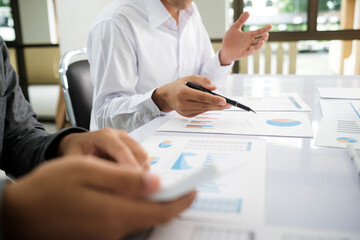 Asisan businessman teamwork meeting and discussing the investment data and report graph.