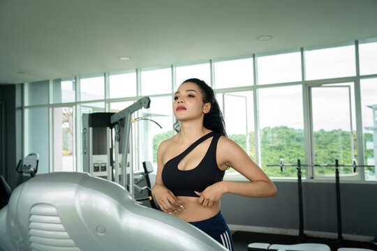 Young woman workout in gym healthy lifestyle.  Young People - women doing sport in the gym for fitness