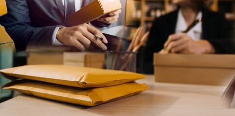 Portrait of Starting small businesses SME owners, two Asian woman check online orders Selling products working with boxs freelance work at home office, sme business online small medium enterprise