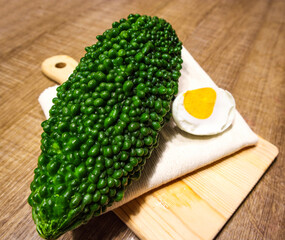 close-up of momordica charantia and salted duck egg