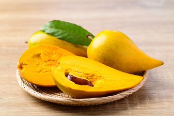 Canistel fruit or Eggfruit in basket on wooden background, Tropical fruit