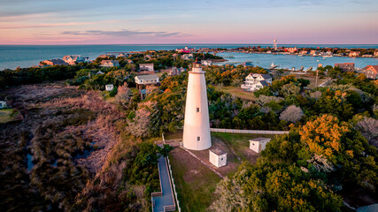 Ocracoke Lighthouse on Ocracoke , North Carolina at sunset.The lighthouse was built to help guide ships through Ocracoke Inlet into Pamlico Sound.