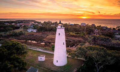 Ocracoke Lighthouse on Ocracoke , North Carolina at sunset.The lighthouse was built to help guide...