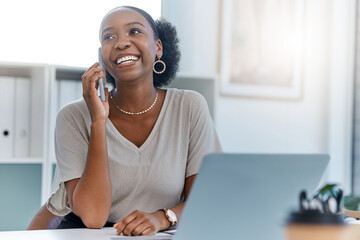 Happy business woman smile talking on phone call or young entrepreneur answering cellphone while sitting in front of work laptop in an office. Female executive smiling and laughing at a funny joke