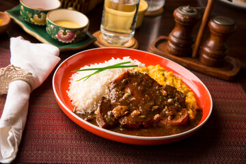 Fried cow liver with locro pumpkin stew Buffet table Peruvian comfort restaurant gourmet food