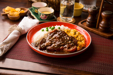 Fried cow liver with locro pumpkin stew Buffet table Peruvian comfort restaurant gourmet food