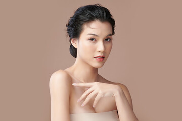 Beautiful young asian woman with clean fresh skin on beige background, Face care, Facial treatment,...