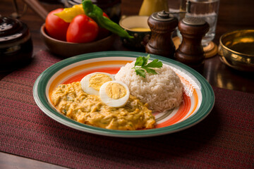 Aji de gallina chicken cream boiled eggs Peruvian comfort restaurant gourmet food