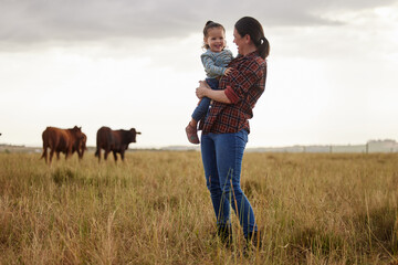 Sustainability, agriculture and countryside farm mother and daughter hug, happy family bonding in...