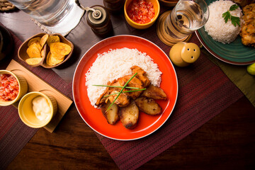 Fototapeta na wymiar Fried chicken stew with baked potatoes Peruvian comfort restaurant gourmet food