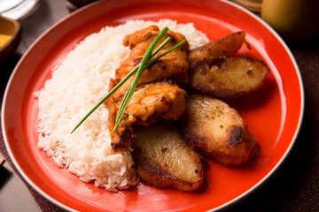 Fried chicken stew with baked potatoes Peruvian comfort restaurant gourmet food