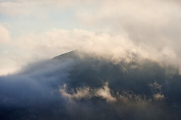 Cloudy sky over mountain ridge in daytime