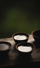 Ceramic cup with tea in the forest.