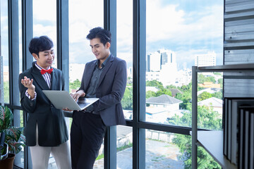 Company executive Young Asian businessman and coaching personal secretary assistant Homosexual businessman LGBT  partners while working together with laptop computer and strategy in business in office