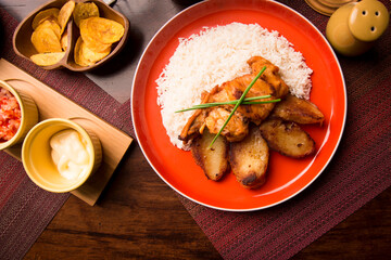 Fried chicken stew with baked potatoes Peruvian comfort restaurant gourmet food