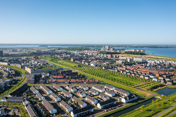 Fototapeta na wymiar Almere Poort district in a modern green growing city in The Netherlands, province Flevoland, suburb of Amsterdam. Aerial drone shot.