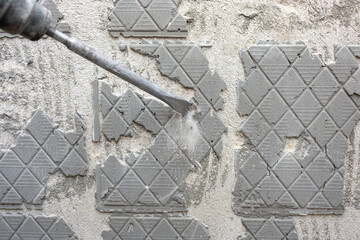 Removing old tile adhesive from the wall with a perforator