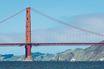 Boat under Golden Gate Bridge in San Fransisco California