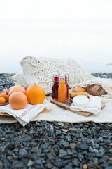 Picnic on the lake shore, a blanket with a basket, fruit and juice