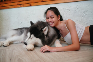 Young woman with her dog at modern house on nature light.