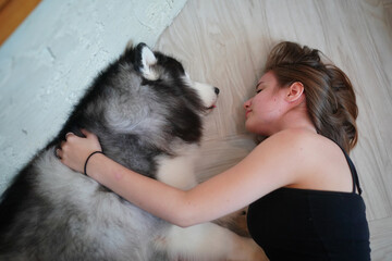 Young woman with her dog at modern house on nature light.