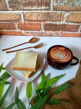 Coffee and bread wtth fork and spoone