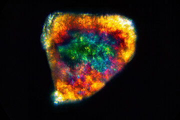 Colorful abstract micrograph of a single grain of sand.