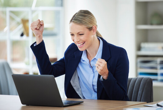 Happy and excited crypto winner celebrating stock market success while reading on laptop, winning and cheering for online bonus in an office. Corporate woman getting good news about investment growth