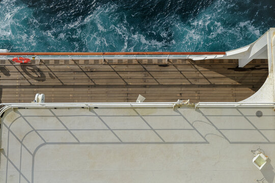 Fototapeta View from open outdoor deck of legendary luxury ocean liner cruise ship on passage during Transatlantic Crossing from Southampton to New York with deck chairs, railing and superstructure