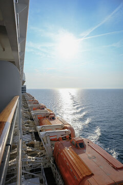 Fototapeta View from open outdoor deck of legendary luxury ocean liner cruise ship on passage during Transatlantic Crossing from Southampton to New York with deck chairs, railing and superstructure