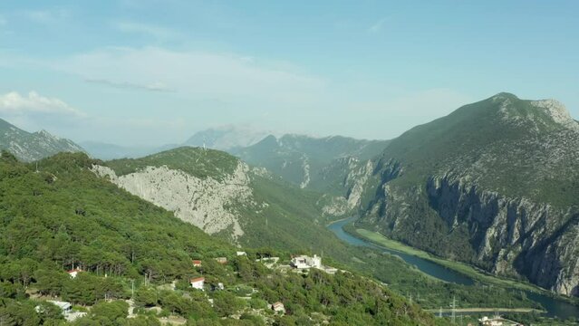Aerial view of the landscape of the mountains of Croatia. The river flows between rocky mountain ranges. High quality 4k footage