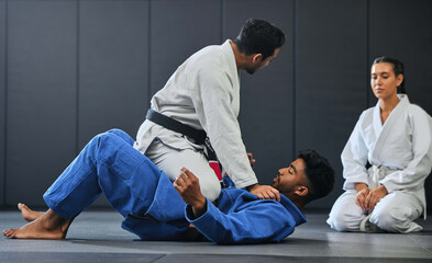 Karate, fitness and martial arts instructor teaching a lesson on fighting and defense training at a...