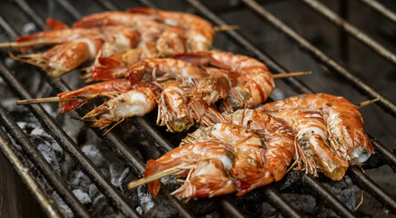 Java, Indonesia, June 13, 2022 - Shrimp on a skewer on a BBQ.