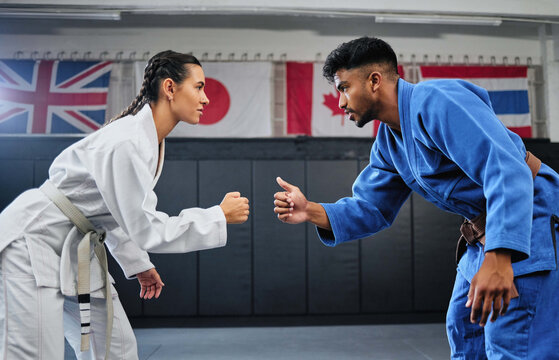 Karate, Mma And Fitness With A Teacher And Student Learning, Training And Doing A Workout For Exercise, Sport And Health. Man And Woman In Fight, Combat Or Self Defense Class In A Gym Studio