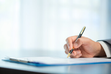 Workplace closeup person professional businesswoman sitting at desk hold pen signing or signature...