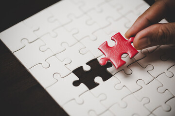 Business woman person hand with puzzle piece idea for strategy and solution. Closeup part of two...